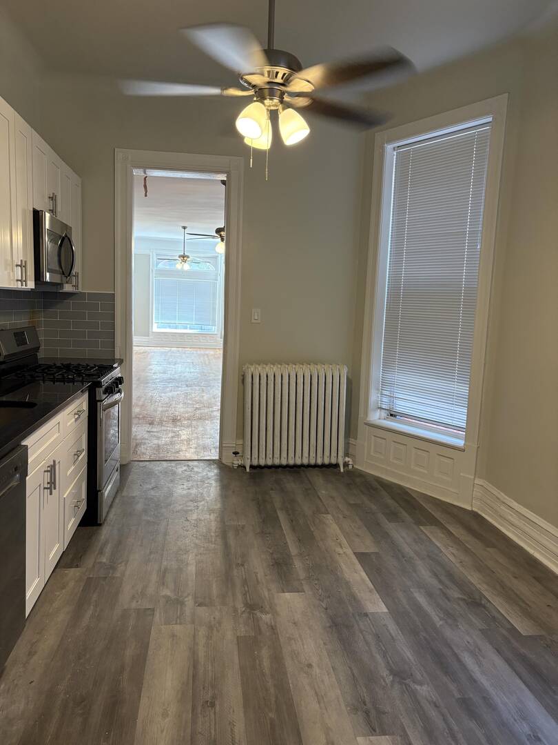 5136 South Blackstone Avenue, Unit 1F Chicago, IL 60615 - Photo 5 of 13 a view of a kitchen with an entryway and a stove top oven