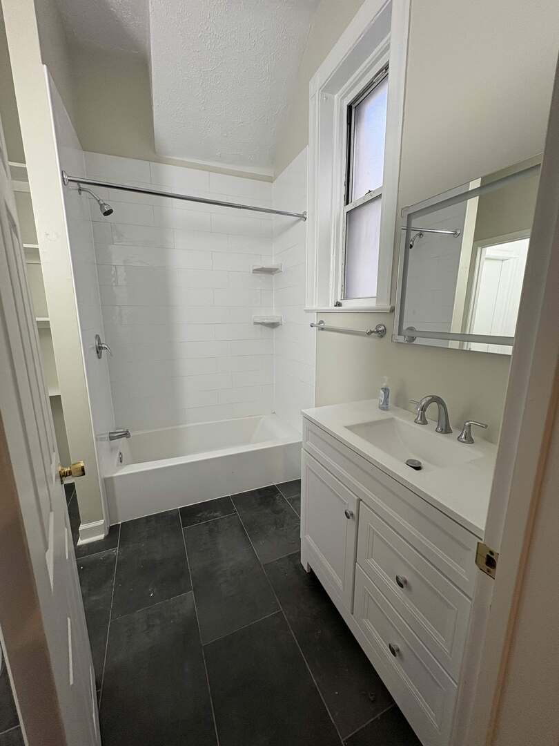 5136 South Blackstone Avenue, Unit 1F Chicago, IL 60615 - Photo 9 of 13 a bathroom with a granite countertop sink toilet and shower