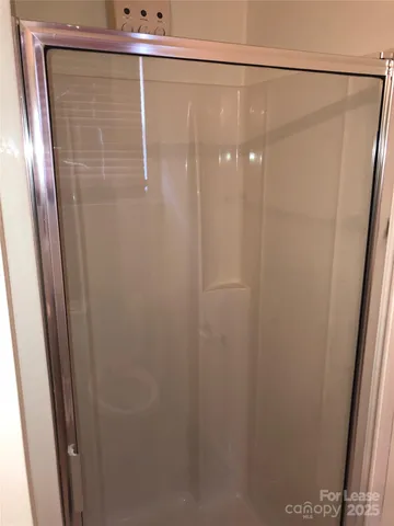a bathroom with a glass shower door