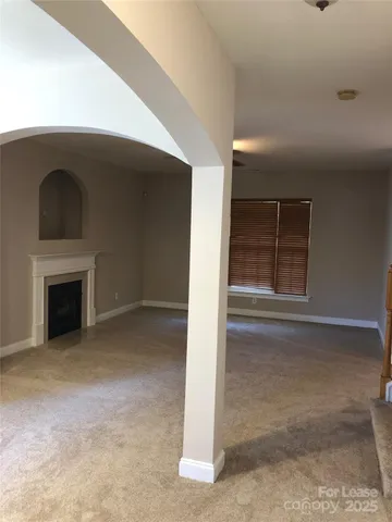 a view of empty room with a fireplace