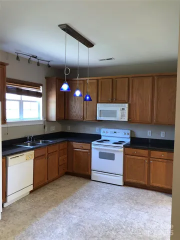 a kitchen with stainless steel appliances granite countertop a sink and cabinets