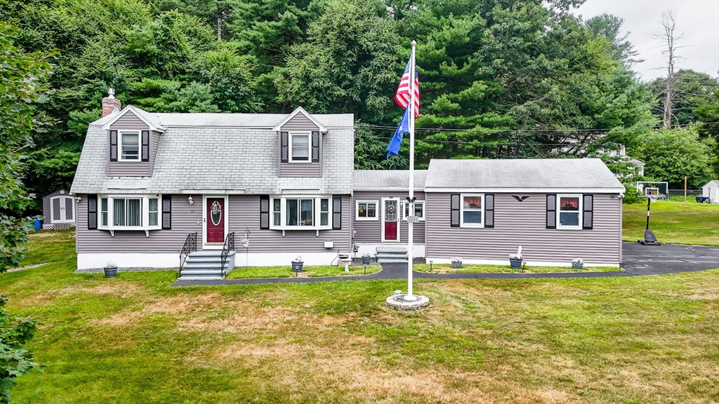 30 Partridge Road Dracut, MA 01826 - Photo 1 of 39 a front view of a house with swimming pool and yard