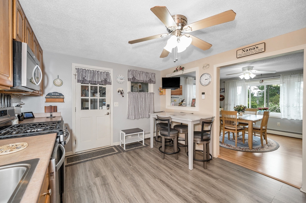 30 Partridge Road Dracut, MA 01826 - Photo 11 of 39 a view of a dining room with furniture a kitchen and chandelier