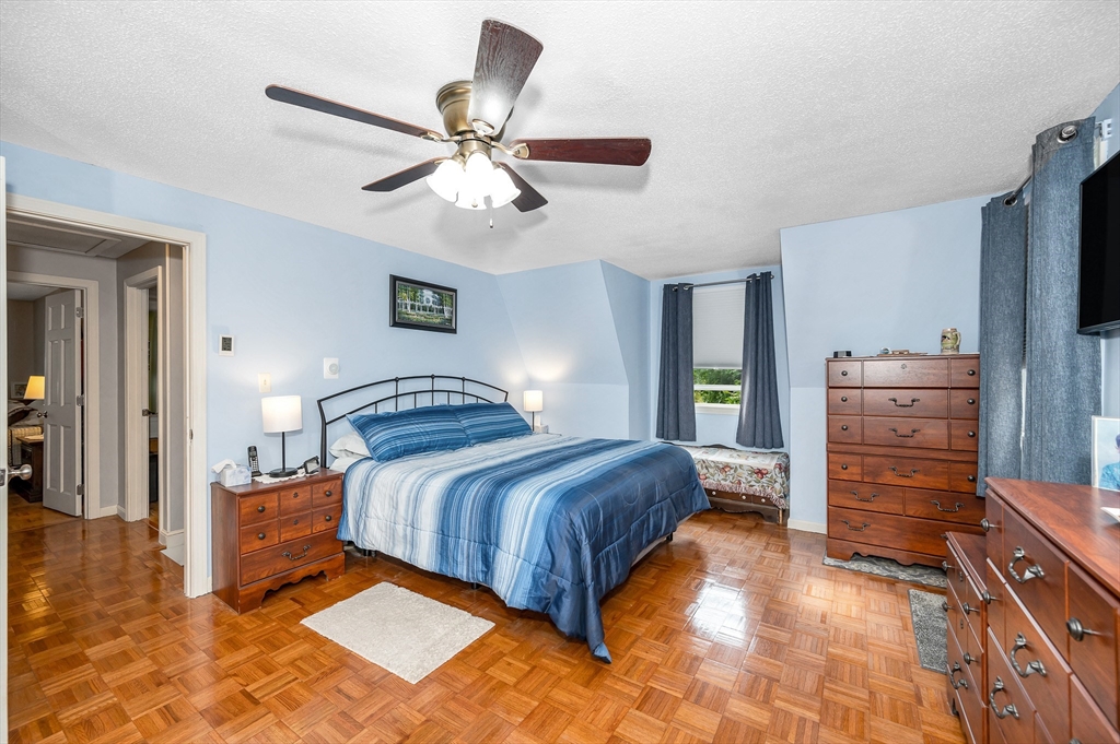 30 Partridge Road Dracut, MA 01826 - Photo 20 of 39 a bedroom with a bed and a chandelier