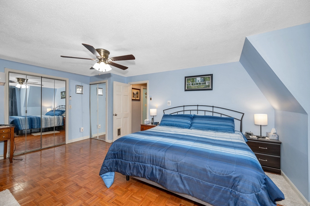 30 Partridge Road Dracut, MA 01826 - Photo 21 of 39 a bedroom with a large bed and a chandelier