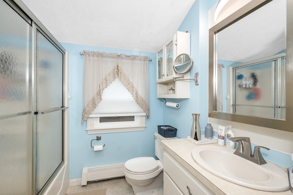 30 Partridge Road Dracut, MA 01826 - Photo 23 of 39 a bathroom with a toilet a sink and a mirror