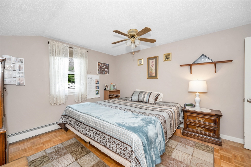 30 Partridge Road Dracut, MA 01826 - Photo 24 of 39 a bedroom with a bed and a chandelier