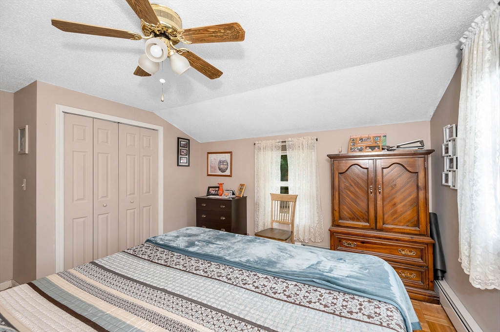 30 Partridge Road Dracut, MA 01826 - Photo 25 of 39 a bedroom with a bed and a chandelier