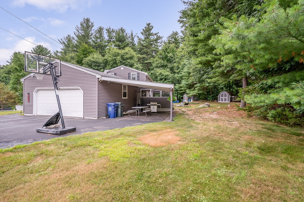 30 Partridge Road Dracut, MA 01826 - Photo 34 of 39 a view of a house with backyard porch and sitting area