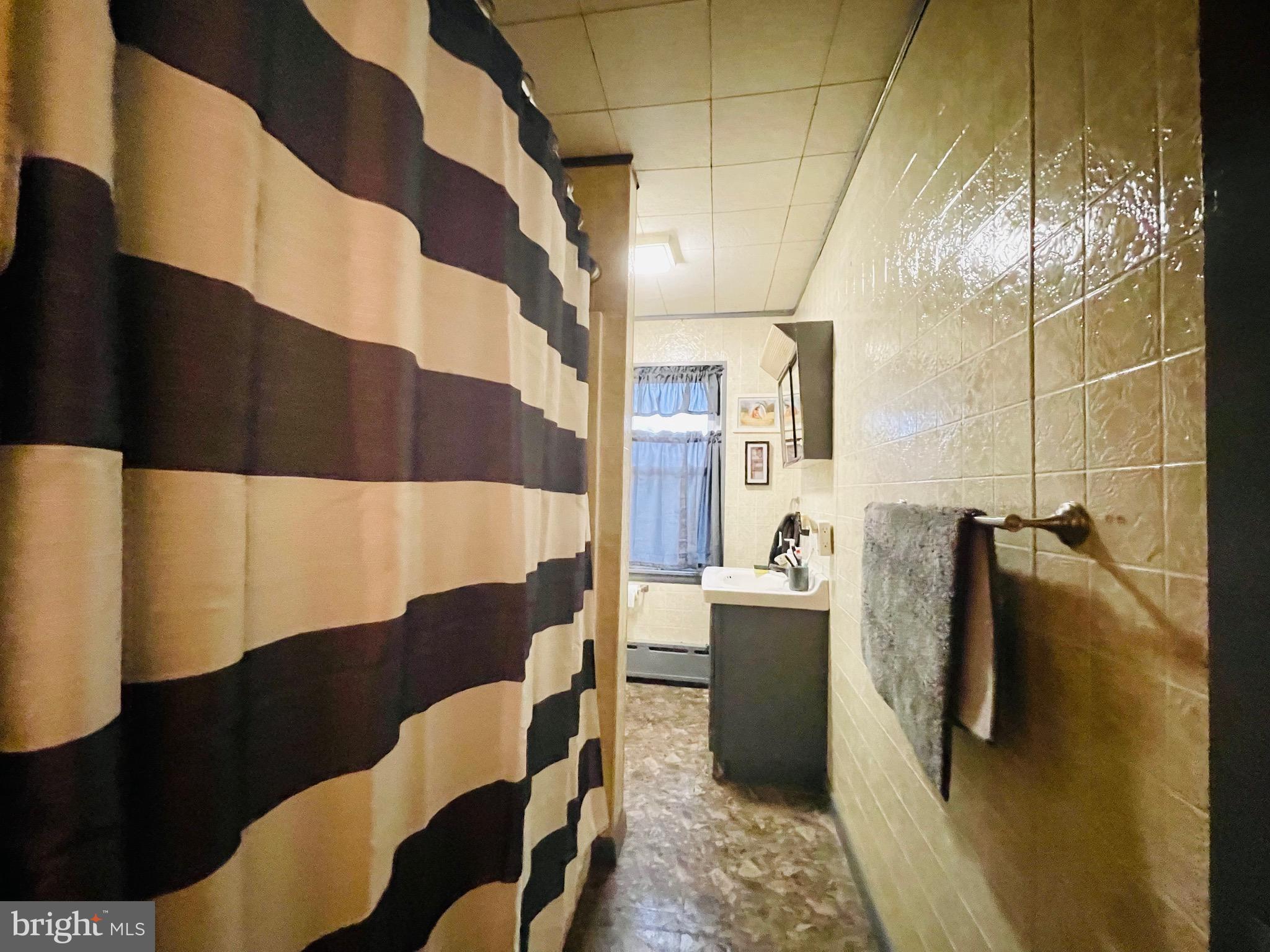 2408 Noble Street Reading, PA 19609 - Photo 23 of 31 a bathroom with a sink and mirror