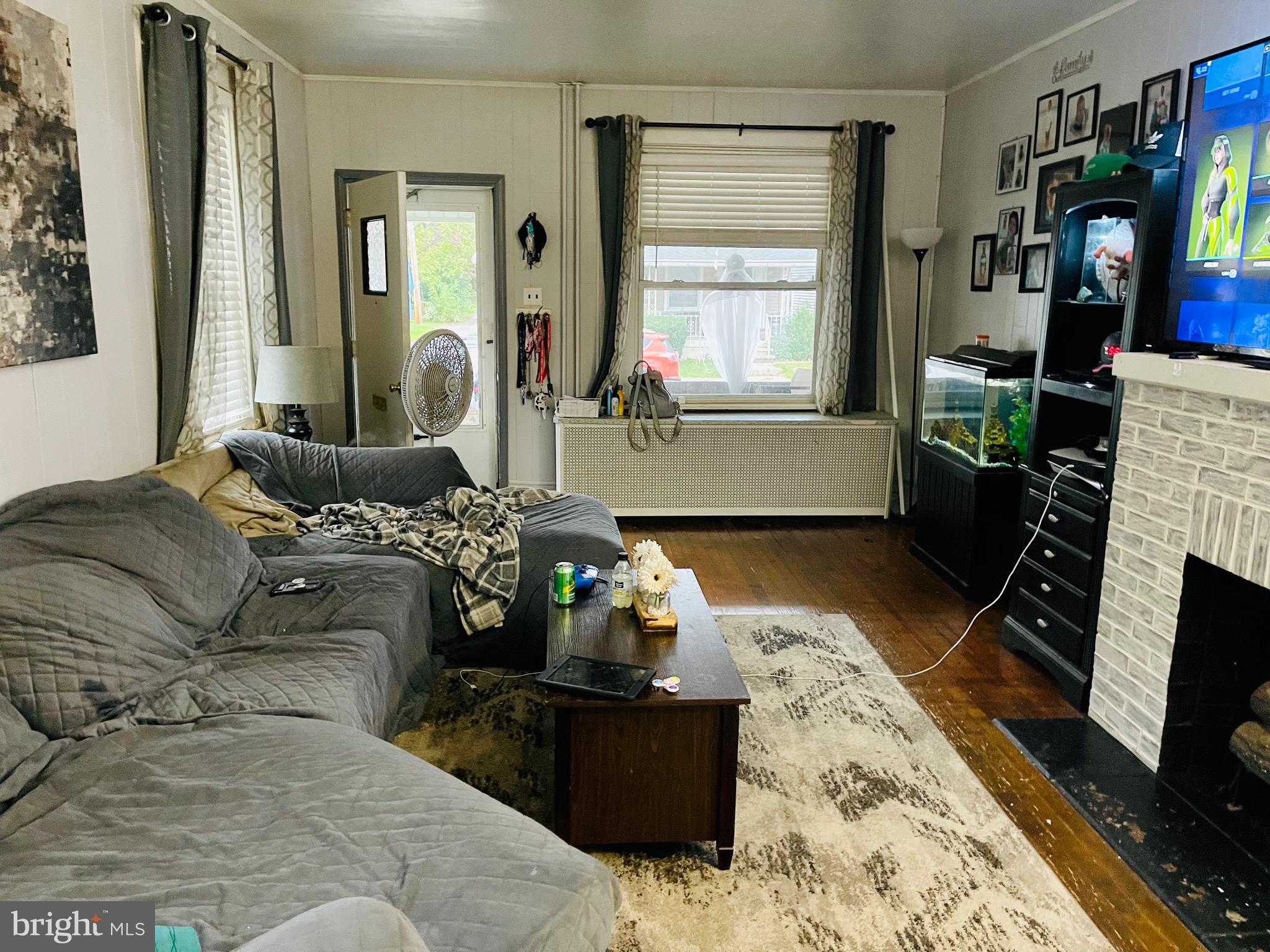 2408 Noble Street Reading, PA 19609 - Photo 10 of 31 a living room with furniture and a fireplace
