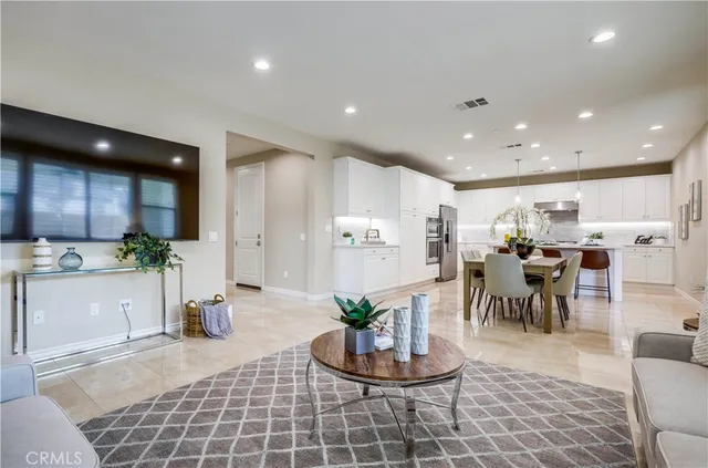 a kitchen with a dining table chairs and white cabinets