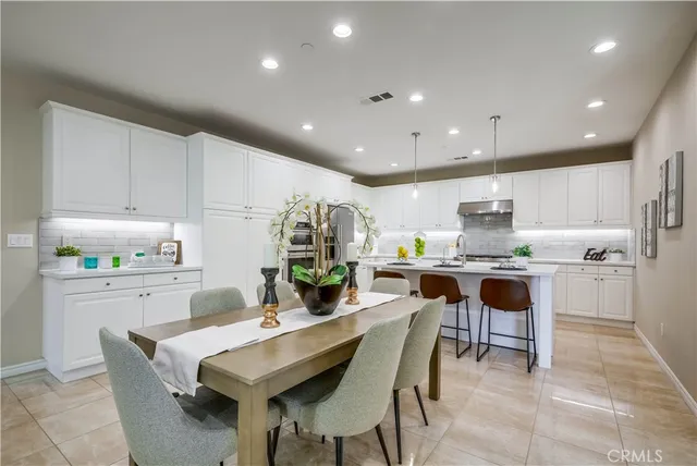a kitchen that has a lot of cabinets in it and appliances