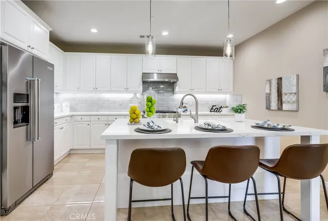 a bedroom with a bed and a potted plant