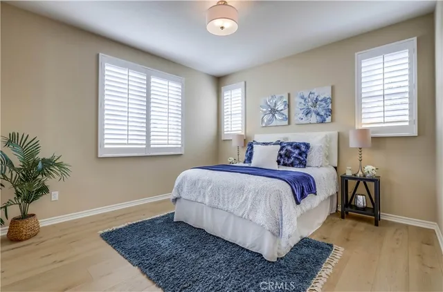a bedroom with a large bed couch and a window