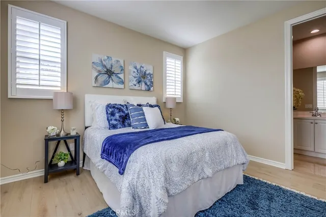 a large white bathroom with a double vanity sink a mirror and a bathtub