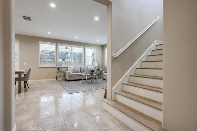 a view of an empty room with wooden floor and closet