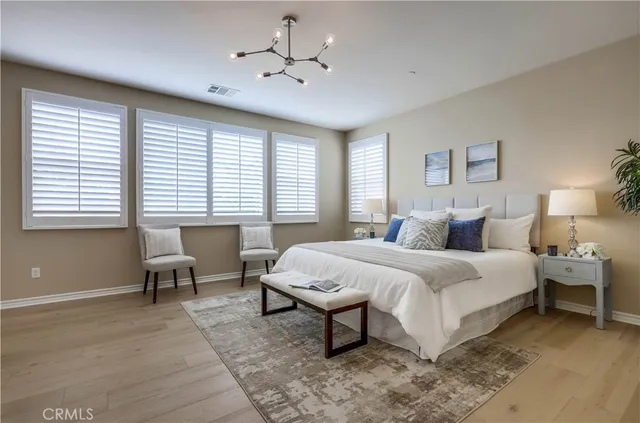 a living room with patio furniture and a potted plant