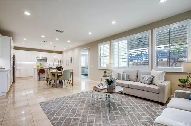 a view of a dining room with furniture and a kitchen