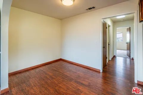 a view of a kitchen with furniture and wooden floor