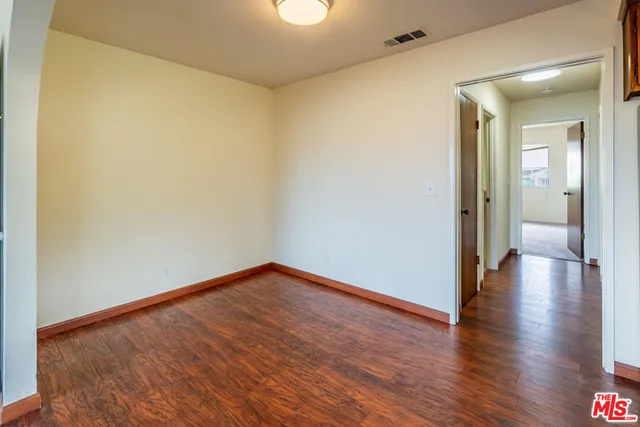 a view of a kitchen with furniture and wooden floor
