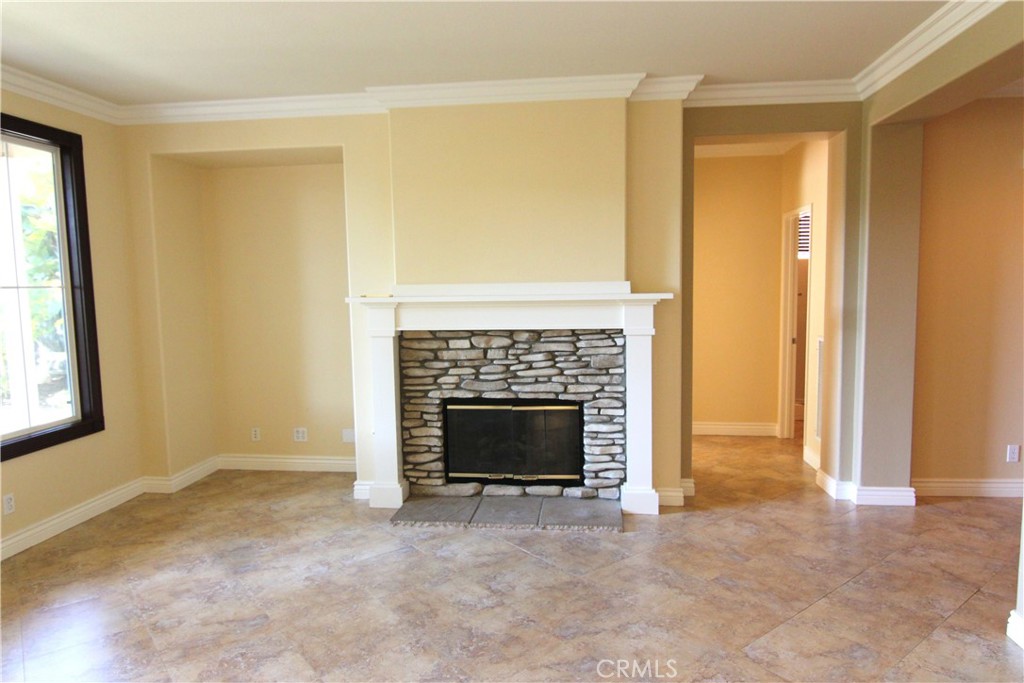 16 Hearthside Road Ladera Ranch, CA 92694 - Photo 7 of 14 a view of an empty room with a fireplace and a window