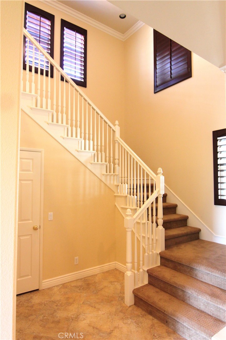 16 Hearthside Road Ladera Ranch, CA 92694 - Photo 9 of 14 a view of staircase with lots of frames on wall and a window