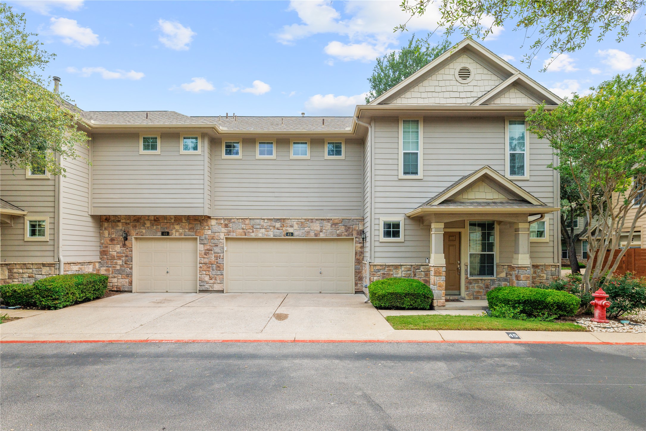 11000 Anderson Mill Road, Unit 45 Austin, TX 78750 - Photo 26 of 32 a front view of a house with a yard and garage