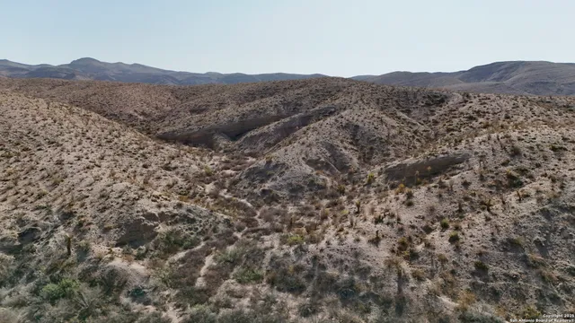 a view of a large mountain with a mountain in the background