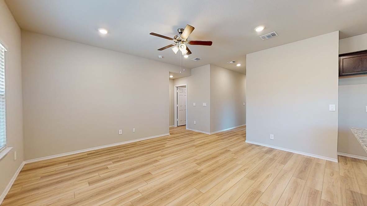 544 Hector Loop Georgetown, TX 78626 - Photo 4 of 22 A warm ambiance fills this spacious living area with resilient wood flooring and recessed lighting.