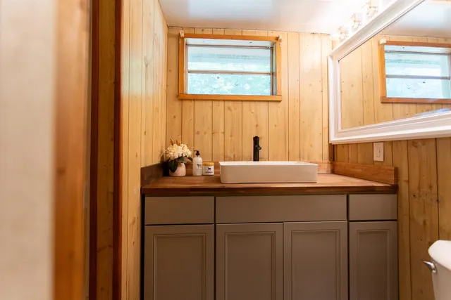 a bathroom with a sink and a mirror