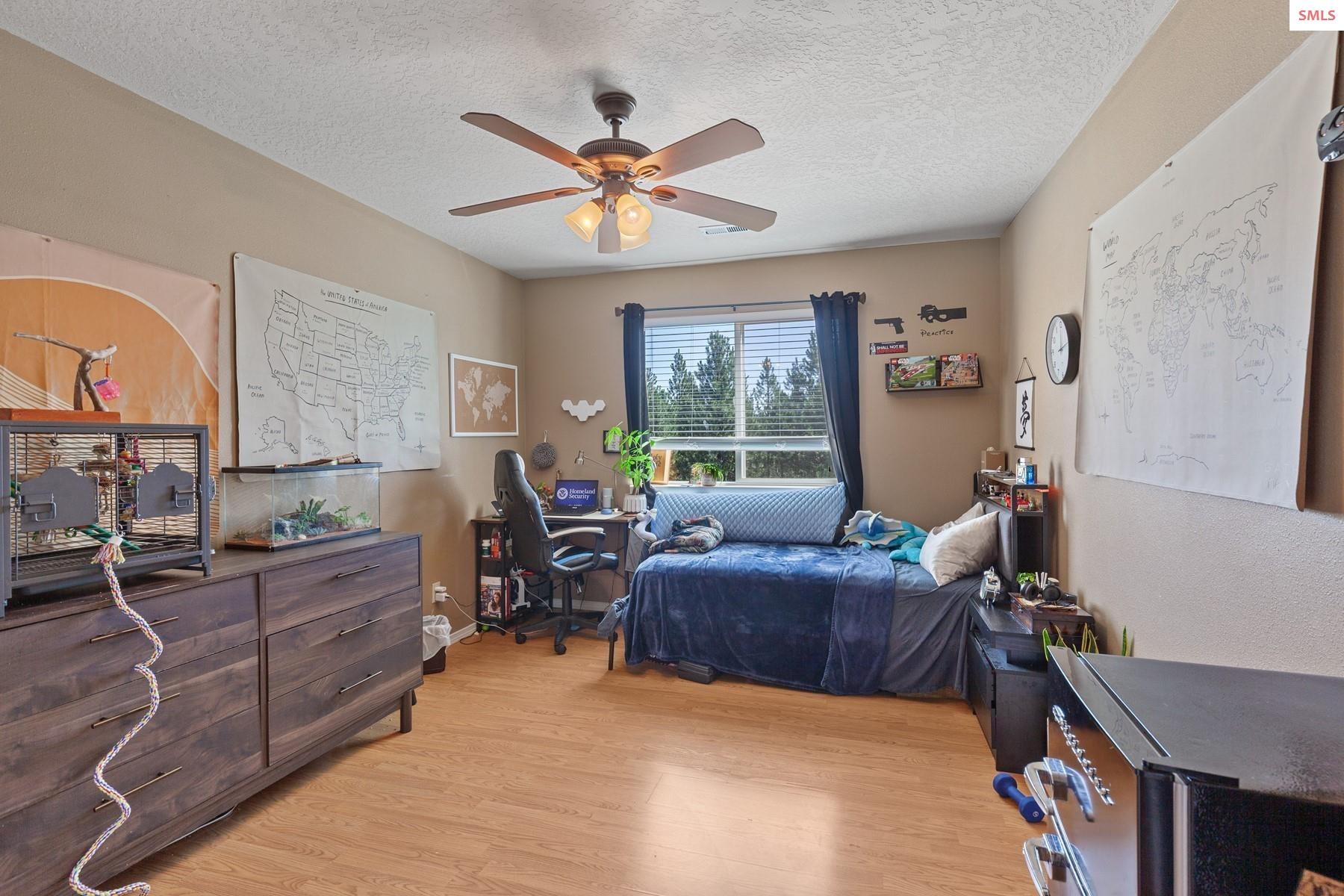 18341 West Highway 53 Rathdrum, ID 83858 - Photo 27 of 41 Upstairs bedroom with ceiling fan and laminate flooring.