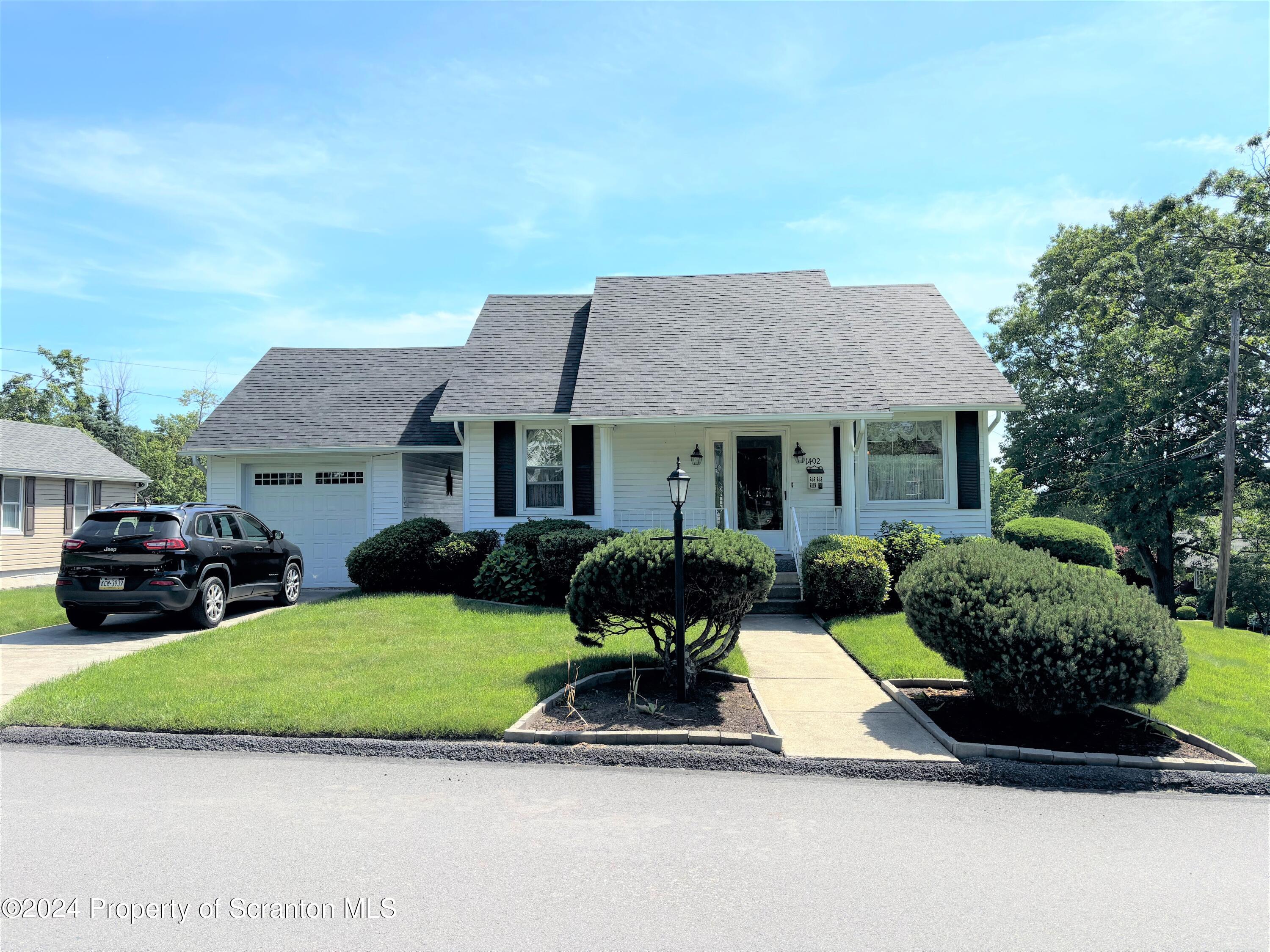 1402 Cherry Street Scranton, PA 18505 - Photo 1 of 25 a house view with a sitting space fire pit and couches in front of a house
