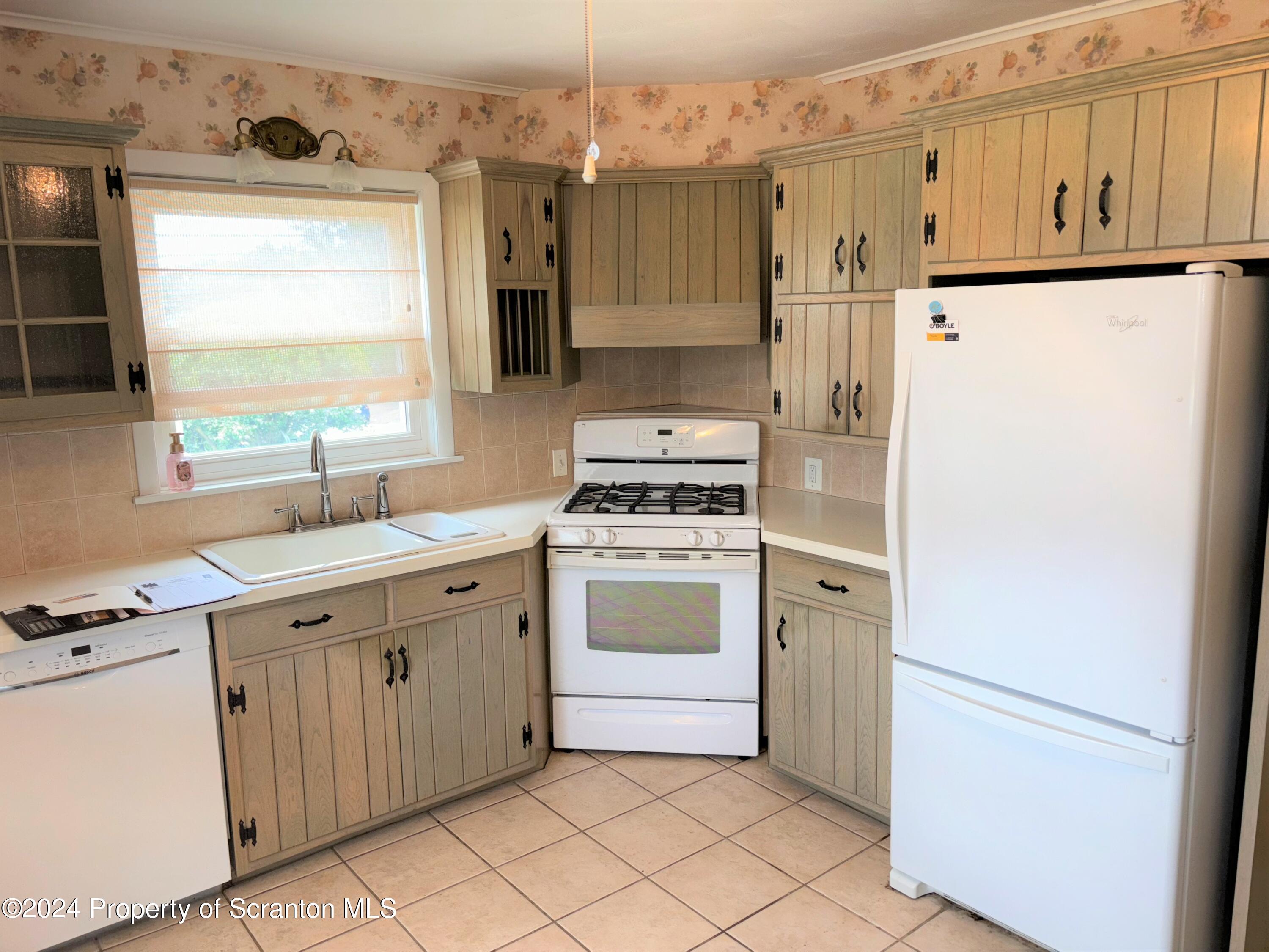 1402 Cherry Street Scranton, PA 18505 - Photo 11 of 25 a kitchen with white cabinets and white appliances