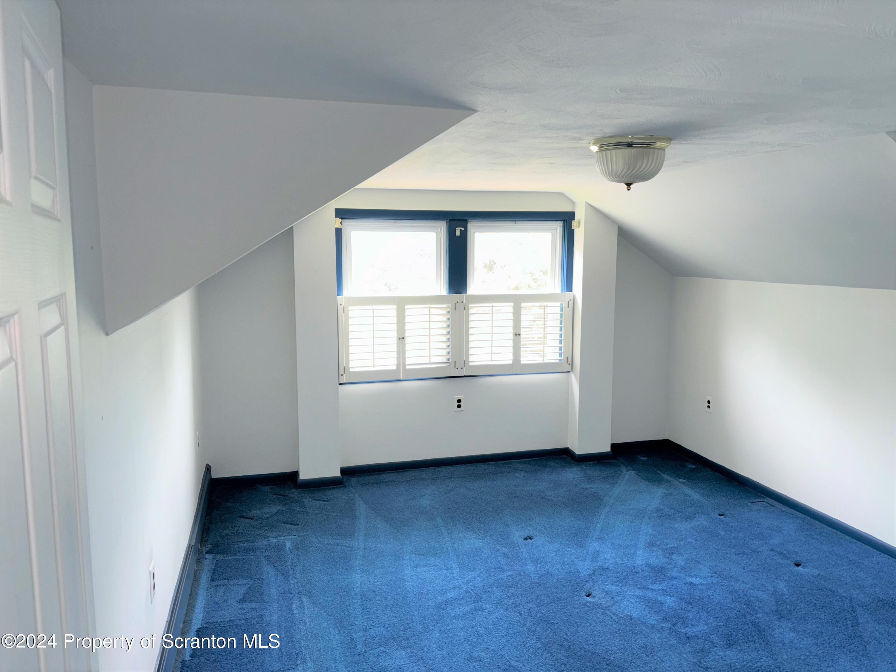 1402 Cherry Street Scranton, PA 18505 - Photo 14 of 25 an empty room with wooden floor and windows