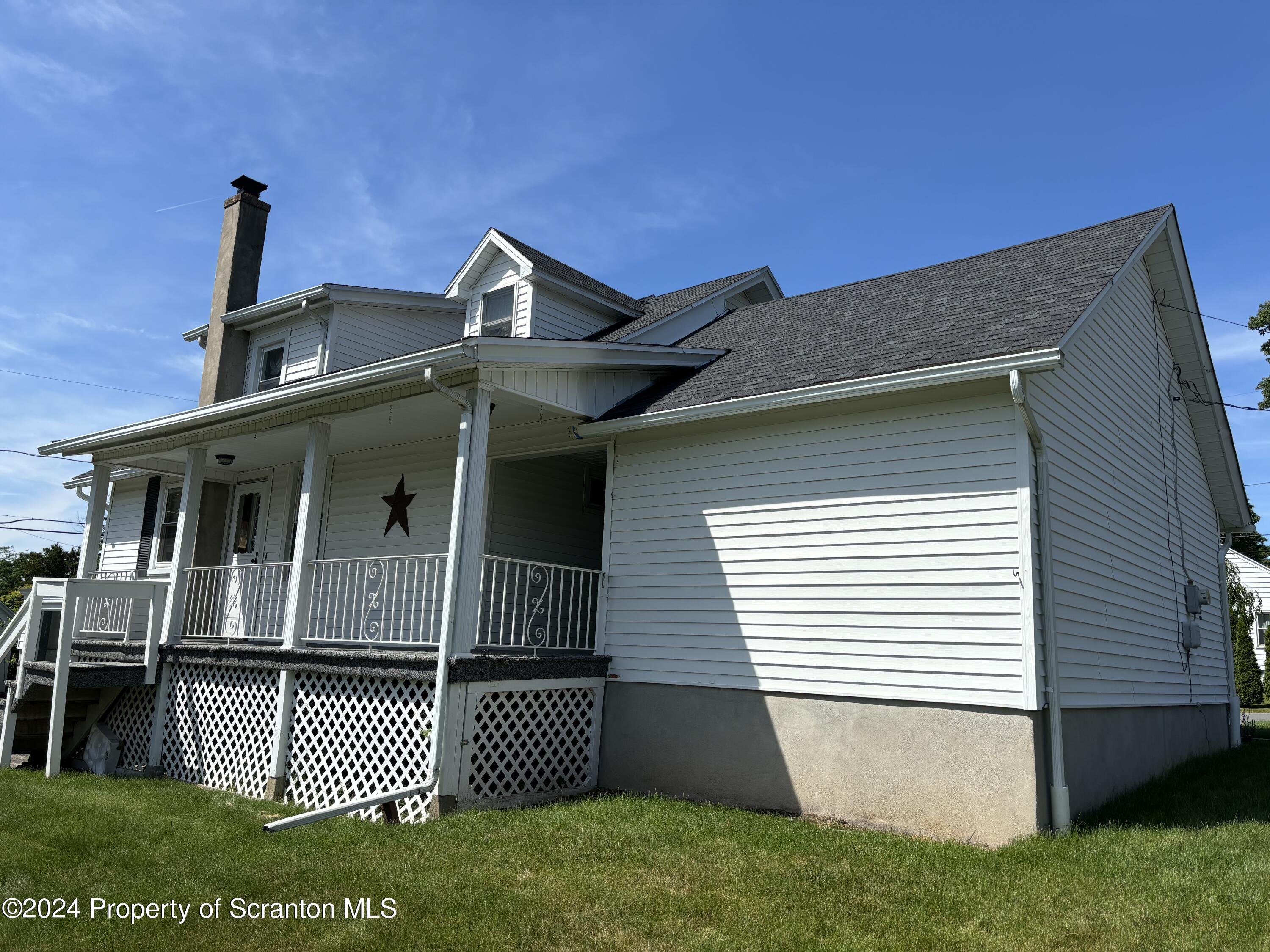 1402 Cherry Street Scranton, PA 18505 - Photo 3 of 25 a front view of a house with a garden
