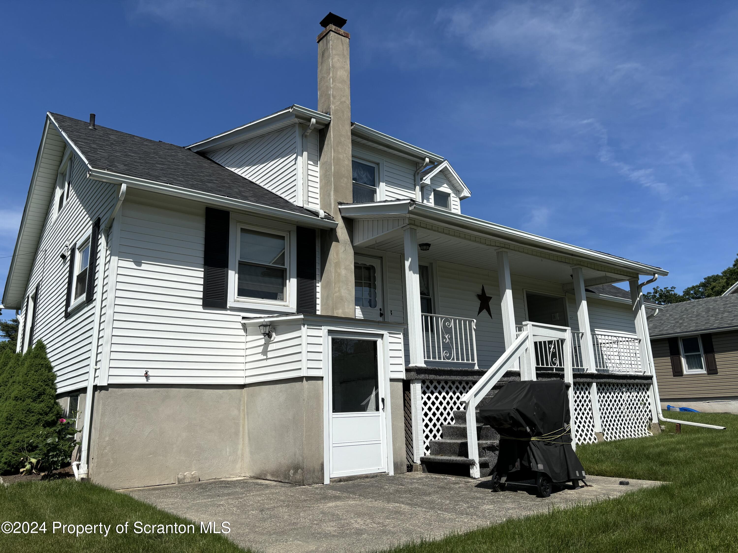 1402 Cherry Street Scranton, PA 18505 - Photo 5 of 25 a front view of a house with a garden