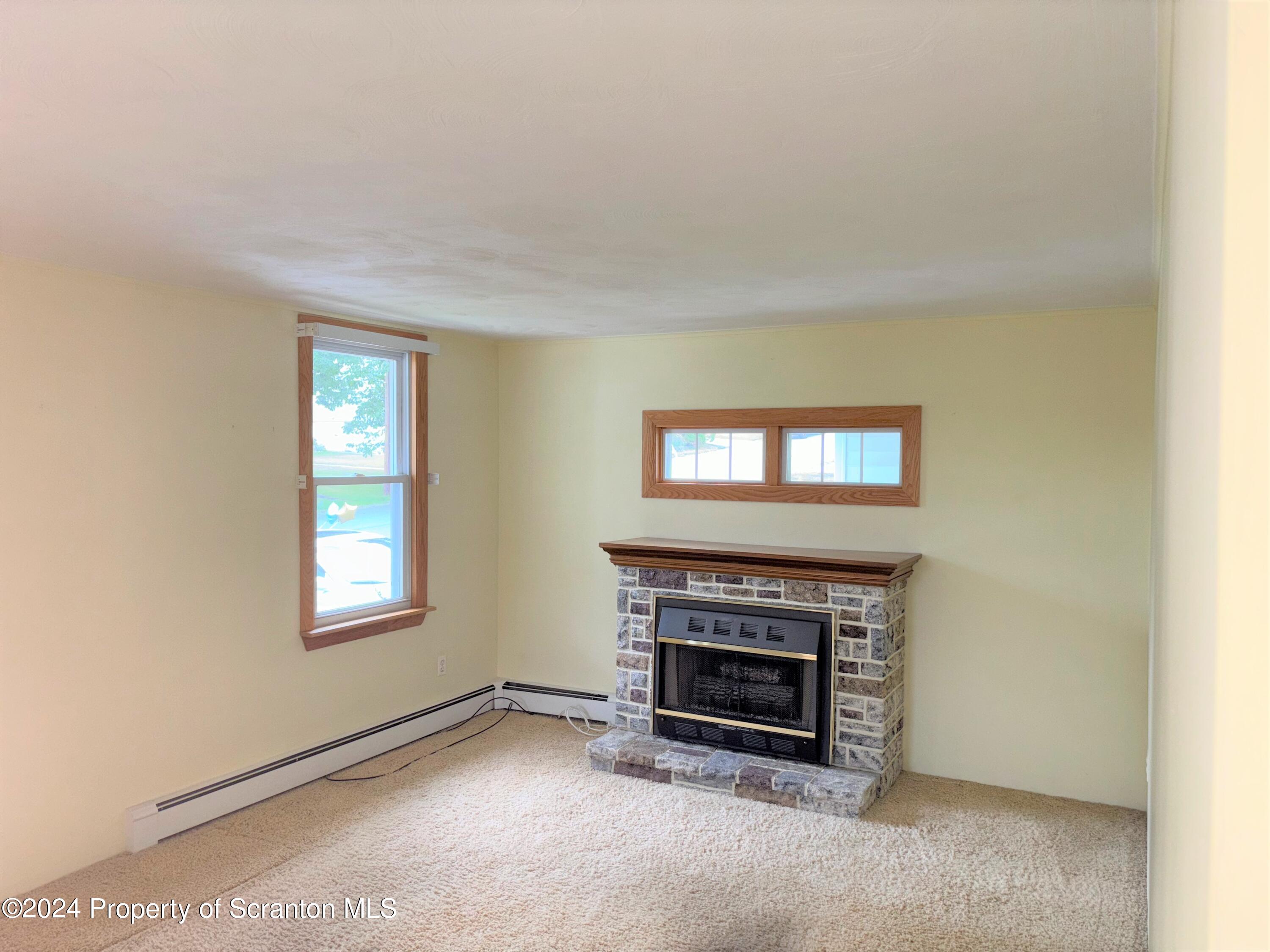1402 Cherry Street Scranton, PA 18505 - Photo 7 of 25 a view of empty room with a fireplace