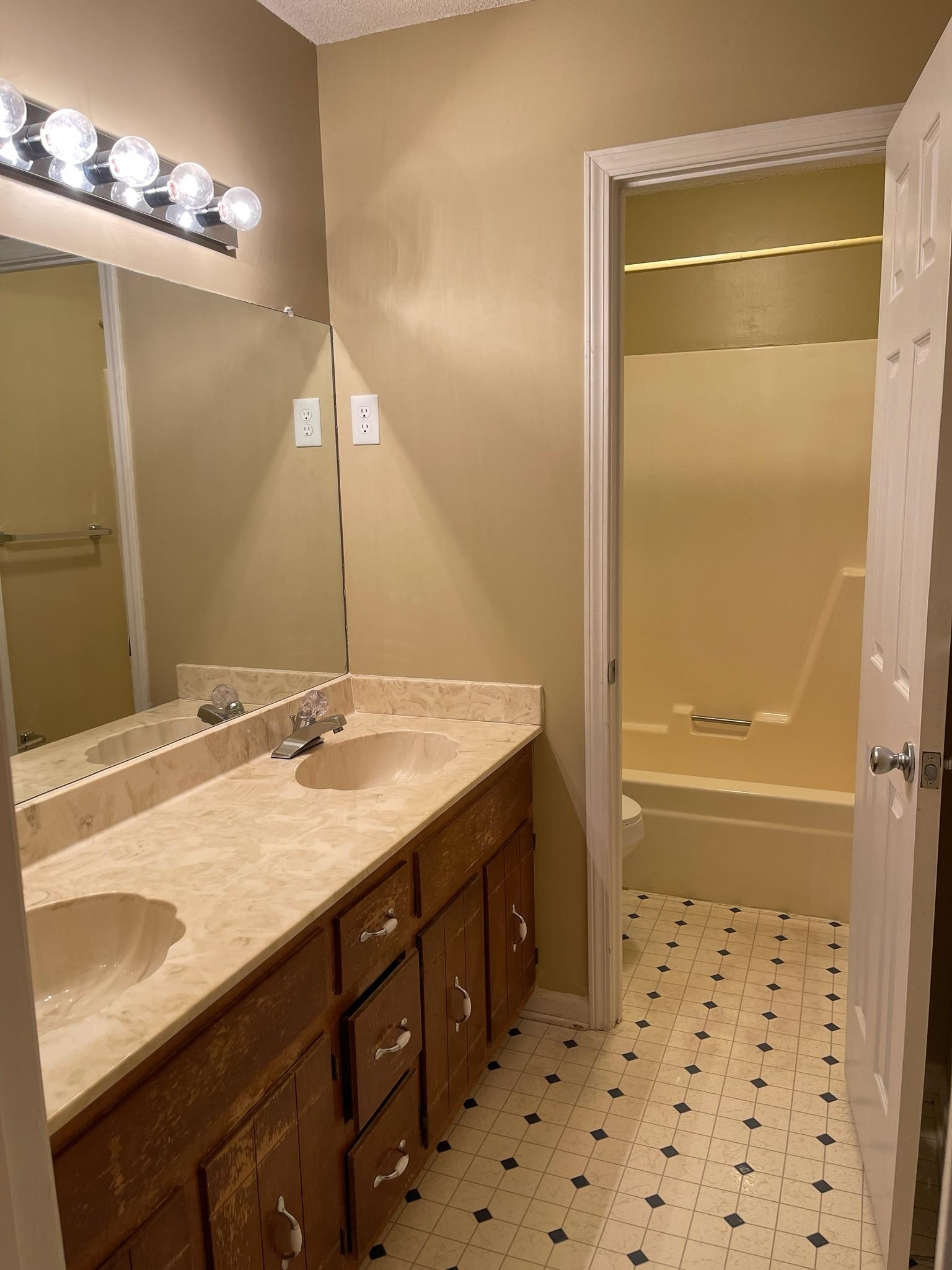 1199 McQuiston Road Brighton, TN 38011 - Photo 13 of 16 Full bathroom with tile patterned floors, vanity, shower combination, and toilet