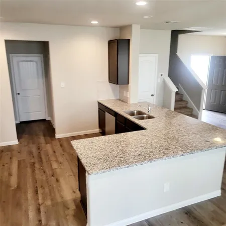 a kitchen with stainless steel appliances granite countertop a sink and a granite counter tops