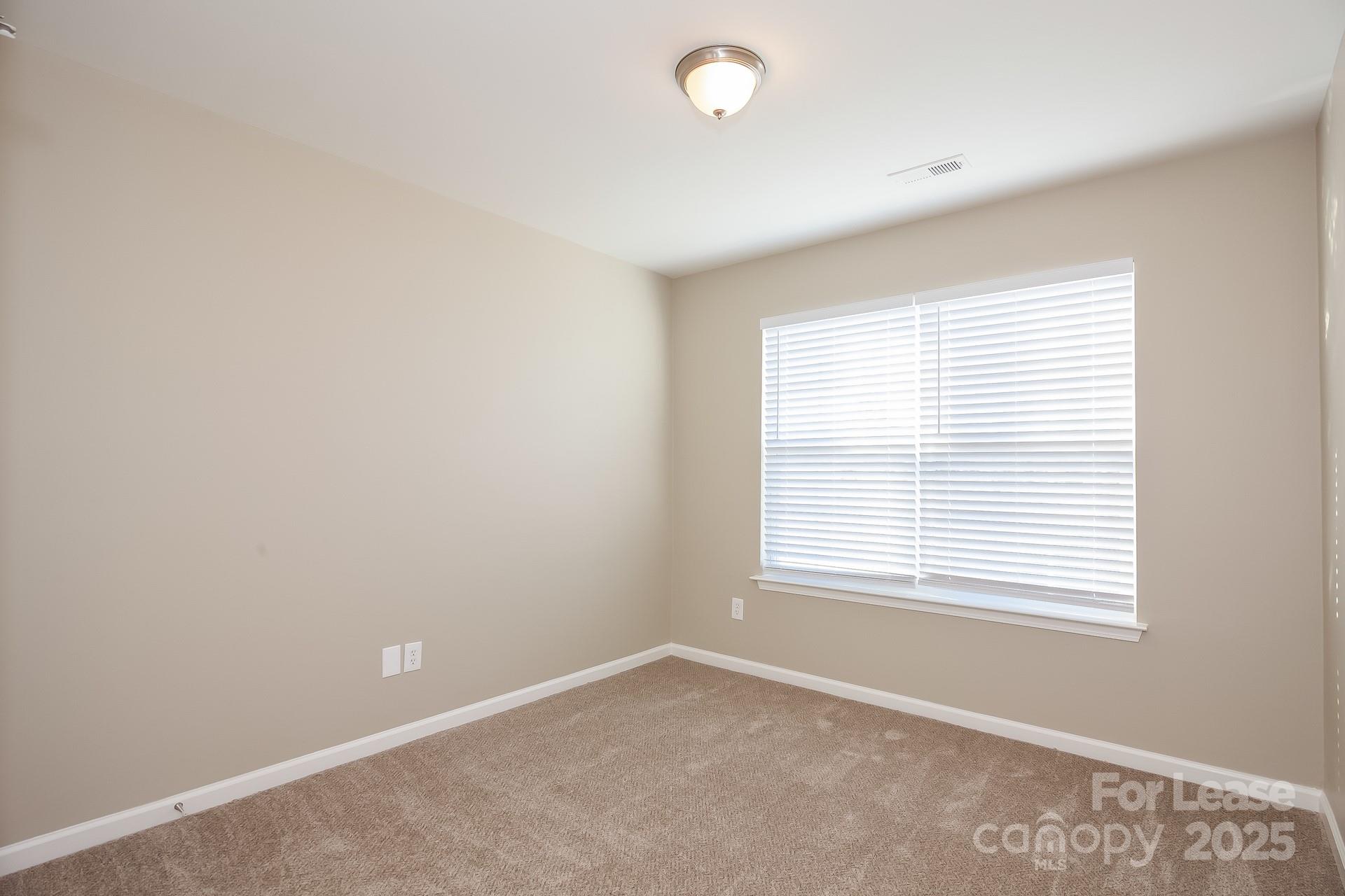 11528 Sidney Crest Avenue Charlotte, NC 28213 - Photo 11 of 15 an empty room with a window