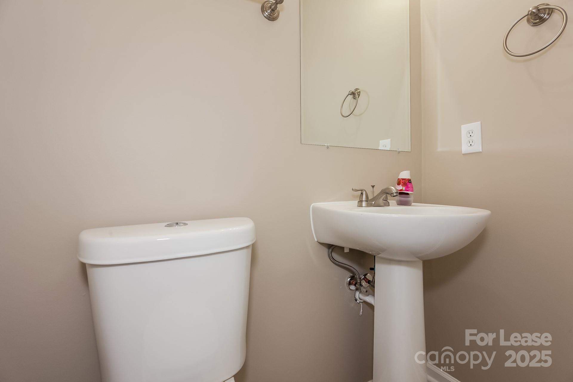 11528 Sidney Crest Avenue Charlotte, NC 28213 - Photo 14 of 15 a bathroom with a sink a toilet and a mirror