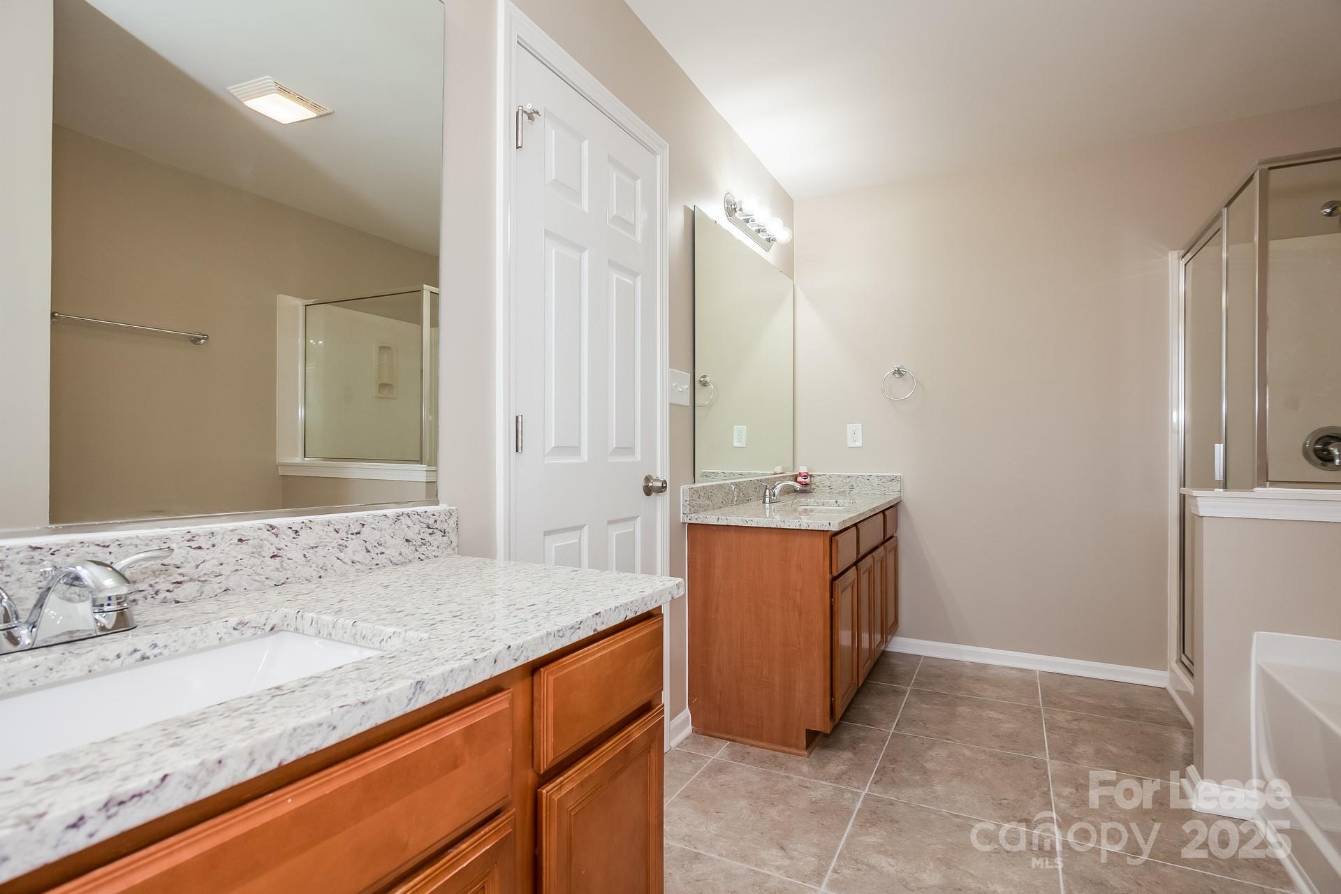 11528 Sidney Crest Avenue Charlotte, NC 28213 - Photo 8 of 15 a bathroom with a granite countertop sink and a mirror