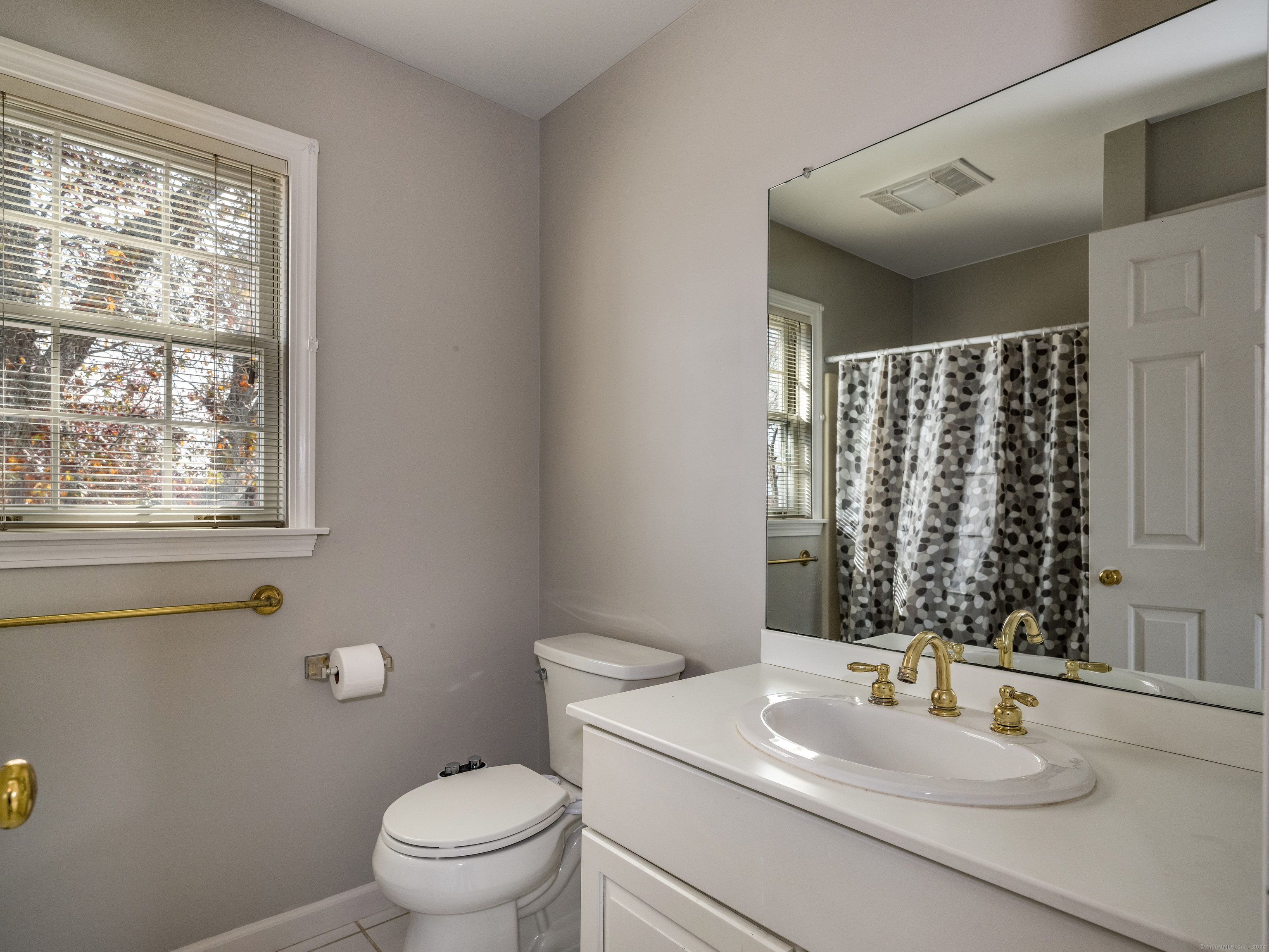 13 Longview Terrace, Unit 13 Madison, CT 06443 - Photo 23 of 31 a bathroom with a sink toilet and mirror