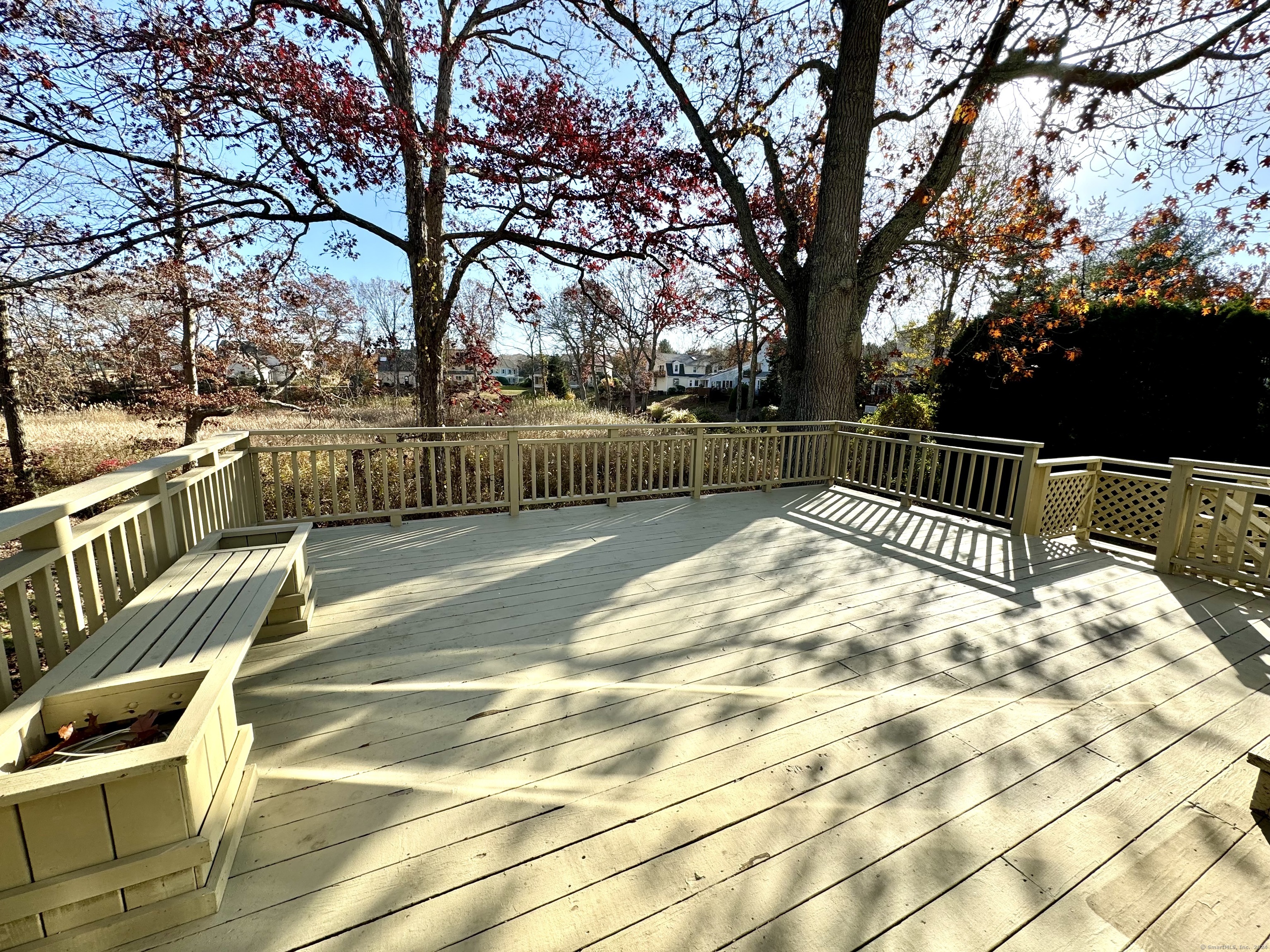 13 Longview Terrace, Unit 13 Madison, CT 06443 - Photo 26 of 31 a view of balcony with wooden floor and trees
