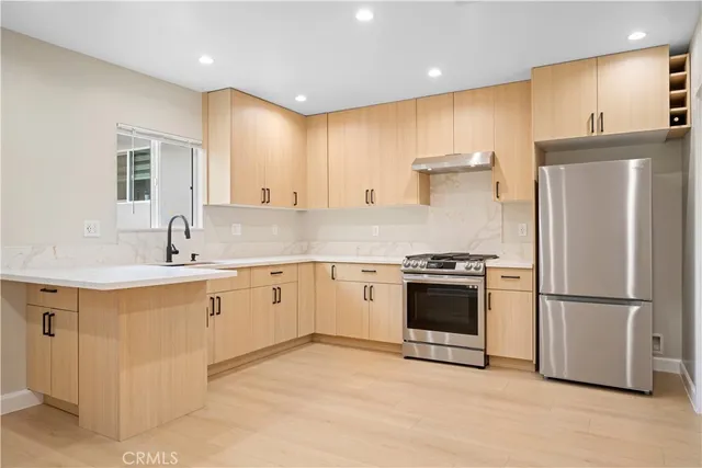 a kitchen with white cabinets and appliances