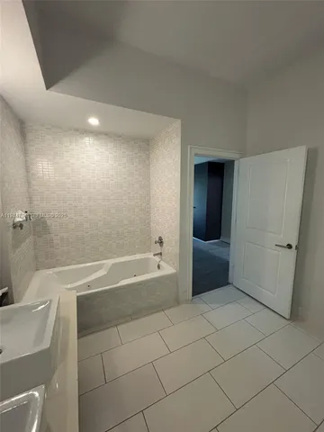 a bathroom with a bathtub and a shower