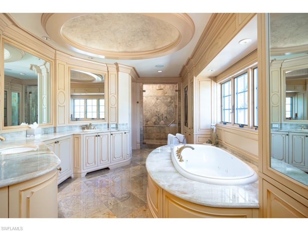 1979 4th Street South Naples, FL 34102 - Photo 12 of 22 a bathroom with a tub sink and mirror