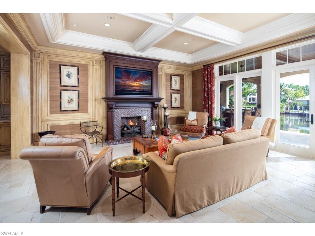 1979 4th Street South Naples, FL 34102 - Photo 4 of 22 a living room with fireplace furniture and a flat screen tv