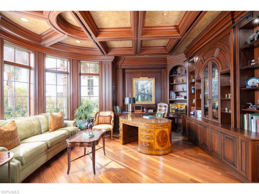 1979 4th Street South Naples, FL 34102 - Photo 8 of 22 a living room with furniture a flat screen tv and a floor to ceiling window